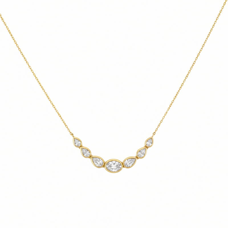 14K yellow gold curved bar necklace with center oval diamond and graduated pear diamonds by Inga Fine Jewelry on white background.