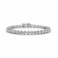 A white gold tennis bracelet featuring a row of round-shaped diamonds, displayed on a clean white background.
