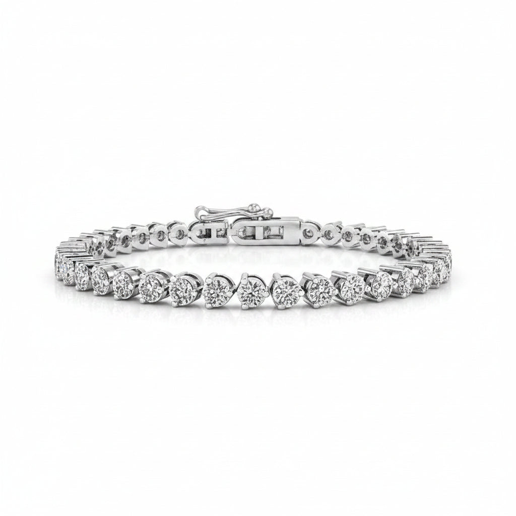 A white gold tennis bracelet featuring a row of round-shaped diamonds, displayed on a clean white background.