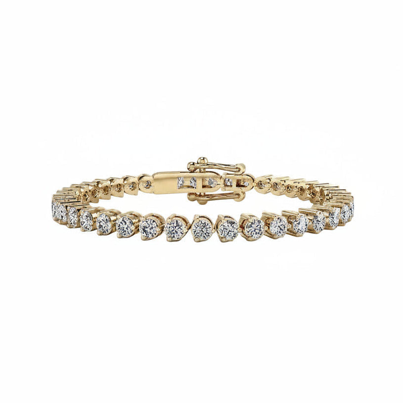 A yellow gold tennis bracelet featuring a row of round-shaped diamonds, displayed on a clean white background.