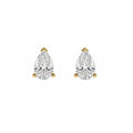 A pair of pear-cut diamond stud earrings in yellow gold settings, shown on a plain white background.