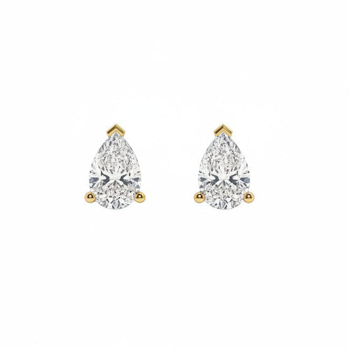 A pair of pear-cut diamond stud earrings in yellow gold settings, shown on a plain white background.