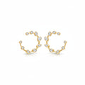 A pair of yellow gold stud design earrings with a wavy, branch-like design set with small clear marquise , oval and round diamonds, shown on a clean white background.