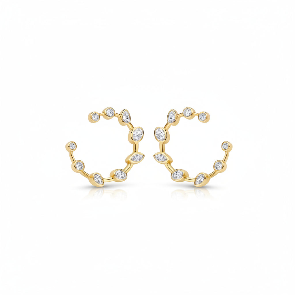 A pair of yellow gold stud design earrings with a wavy, branch-like design set with small clear marquise , oval and round diamonds, shown on a clean white background.