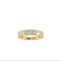 A yellow gold eternity ring featuring a row of baguette-cut diamonds, shown against a plain white background.