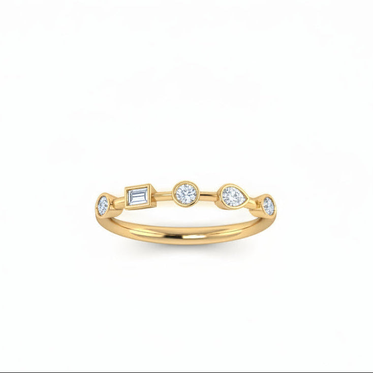 A delicate yellow gold ring featuring five small multi shaped-cut lab grown diamondsin spaced out setting, diamonds 1/2 in a row, photographed on a clean white background.