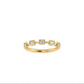 A delicate yellow gold ring featuring five s emerald-cut lab grown diamonds in spaced out setting, diamonds 1/2, photographed on a clean white background.