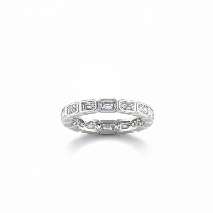 A white gold full eternity ring featuring a continuous row of baguette-cut lab grown diamonds shown on a clean white background with a soft reflection.