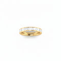 A yellow gold eternity ring featuring a row of east-west set baguette-cut lab grown diamonds, shown on a plain white background.

