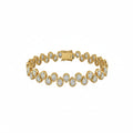 A yellow gold tennis bracelet featuring  teardrop-shaped, bezel set diamonds in a row with a rectangular clasp, shown on a plain white background.