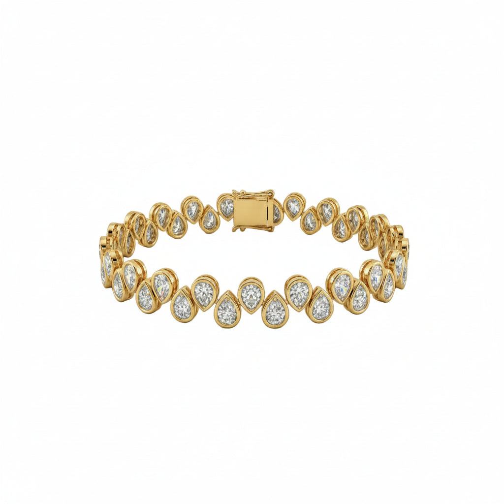 A yellow gold tennis bracelet featuring  teardrop-shaped, bezel set diamonds in a row with a rectangular clasp, shown on a plain white background.