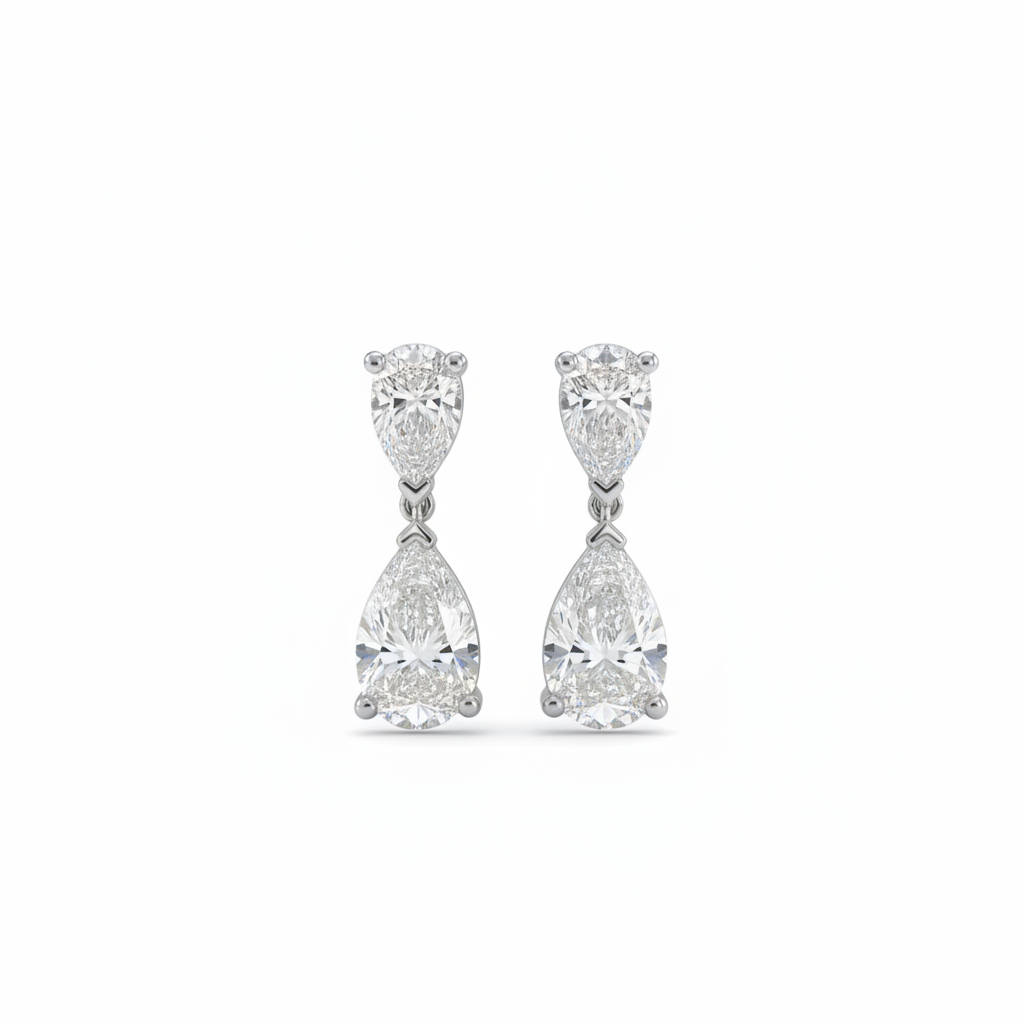 A pair of white gold drop earrings featuring two pear-cut diamonds, set against a plain white background.