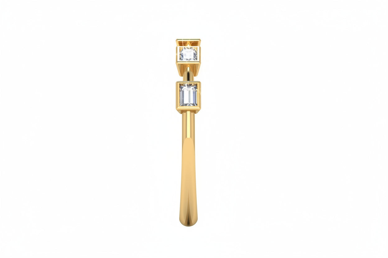 A delicate yellow gold ring featuring five s emerald-cut lab grown diamonds in spaced out setting, diamonds 1/2, photographed on a clean white background with ring side view.