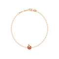 A delicate rose gold chain bracelet with a small apple charm featuring pink gemstone accents, displayed on a clean white background.