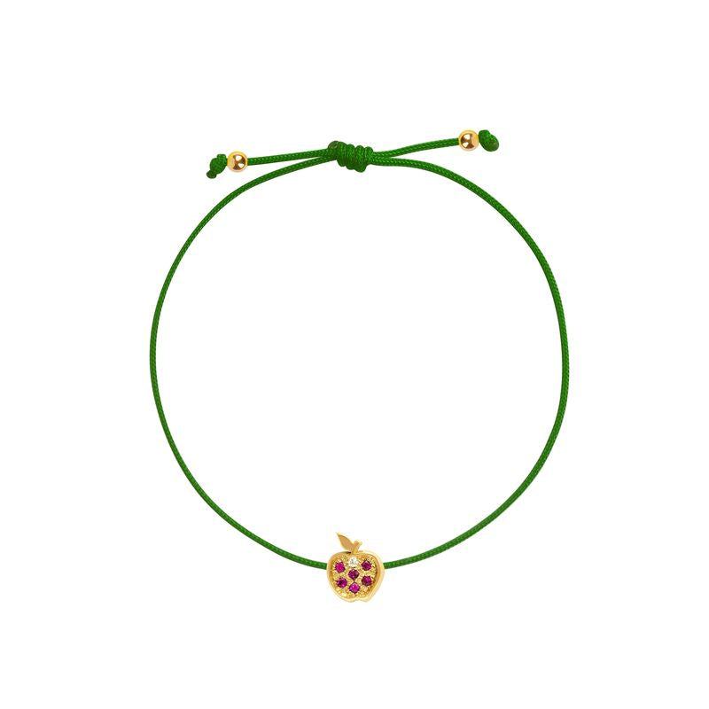 A green adjustable cord bracelet featuring a small yellow gold apple charm embellished with purple gemstones, set against a plain white background.