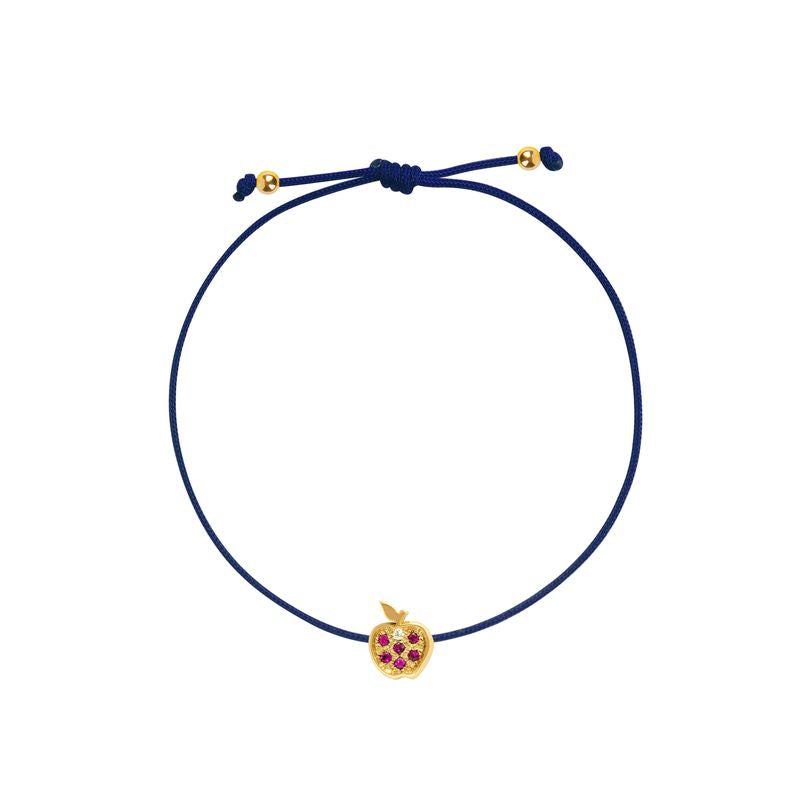 A navy blue cord bracelet with a small gold apple charm set with red gemstones, shown on a plain white background.