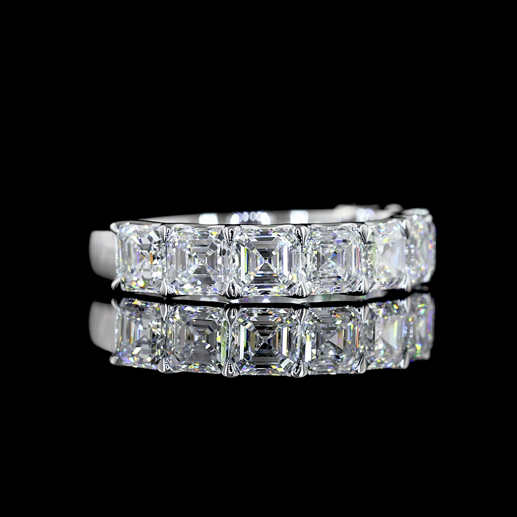A white gold Asscher Diamond Prong set 1/2 eternity ring featuring a continuous row of asscher cut lab grown diamonds, shown on a clean black background.