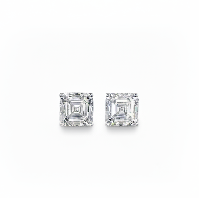Pair of white gold asscher-shaped stud earrings on a white background
