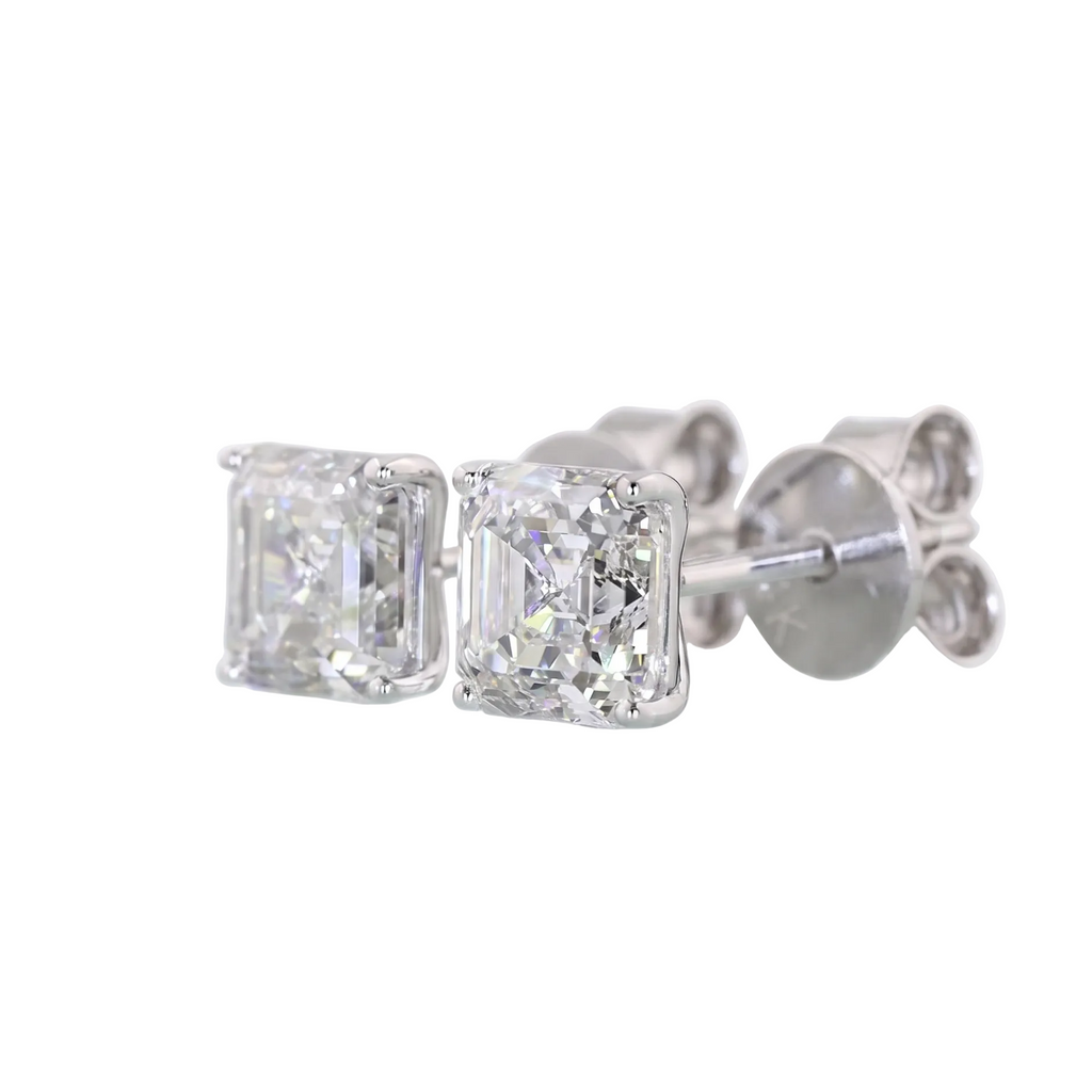 A pair of asscher stud diamond earrings in a white gold setting, shown against a plain white background.