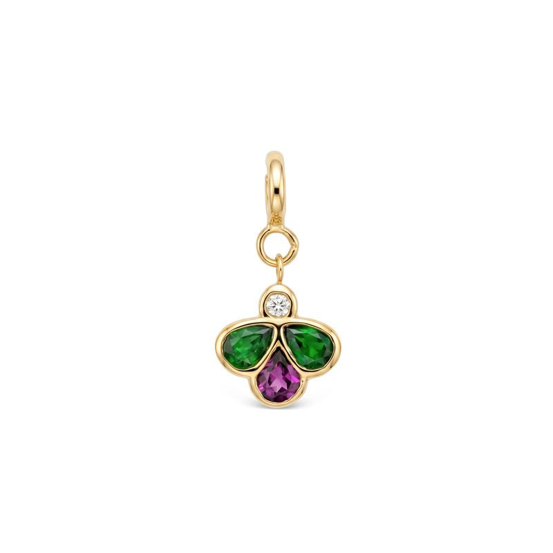 A yellow gold charm pendant featuring a three-petal bee design with a green gemstones on the left and right, a purple pear-cut stone in the center, and a small clear round-cut diamond at the top, set in a polished gold bezel with a hanging loop.