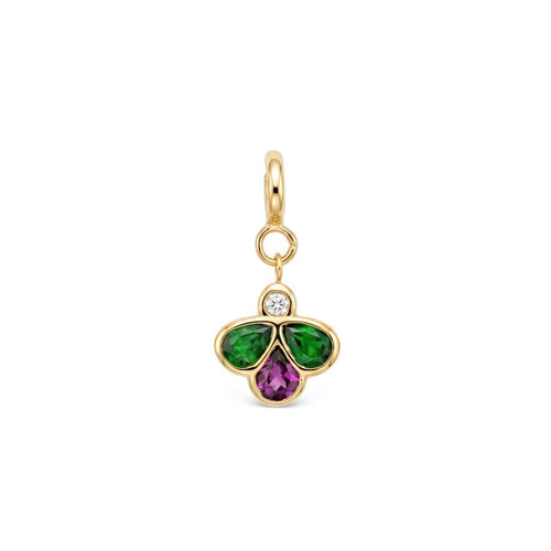 A yellow gold charm pendant featuring a three-petal bee design with a green gemstones on the left and right, a purple pear-cut stone in the center, and a small clear round-cut diamond at the top, set in a polished gold bezel with a hanging loop.