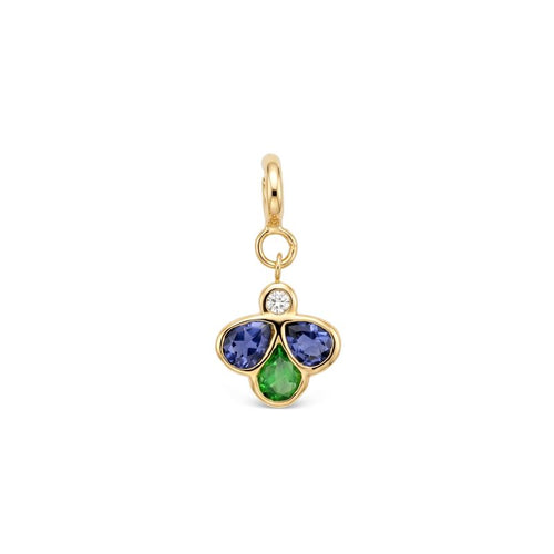 A yellow gold charm pendant featuring three flower-like stones in blue, green gemstones with a small clear round diamond above them, set against a plain white background.