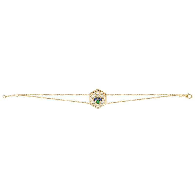 A delicate gold double chain bracelet featuring a central hexagonal charm with a green and blue stone cluster, set against a plain white background.