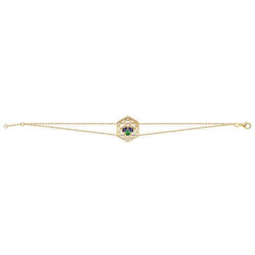 A delicate gold double chain bracelet featuring a central hexagonal charm with a green and blue stone cluster, set against a plain white background.