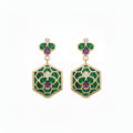 A pair of gold drop earrings featuring green and purple enamel floral motifs, with small round diamonds, set against a plain white background.