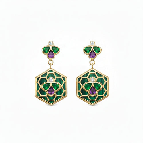 A pair of gold drop earrings featuring green and purple enamel floral motifs, with small round diamonds, set against a plain white background.