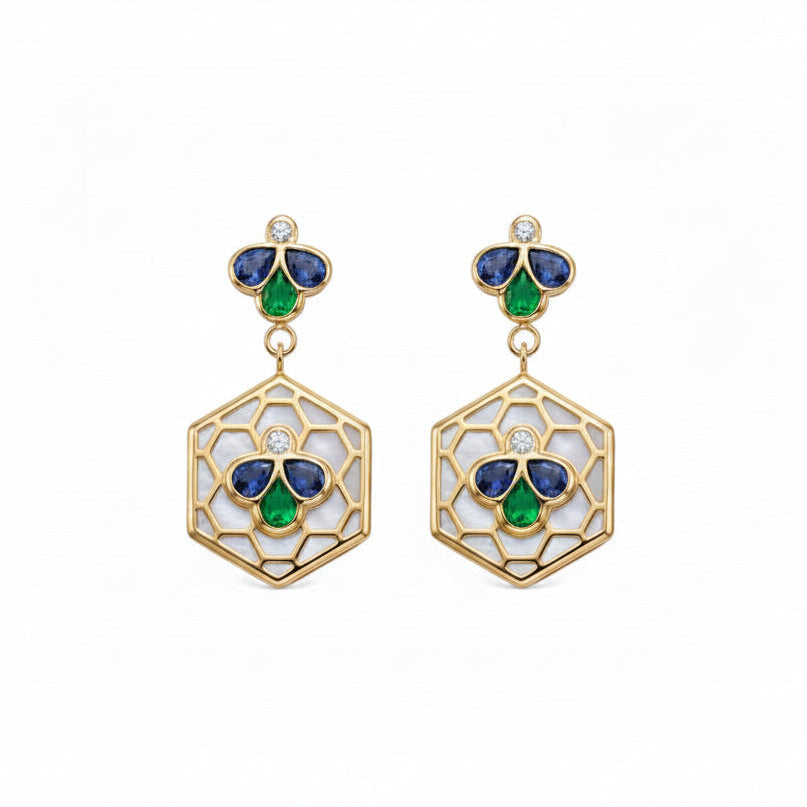 A pair of gold drop earrings featuring a hexagonal openwork design with white inlay, accented by blue and green enamel-like sections and a small round diamond at the top.