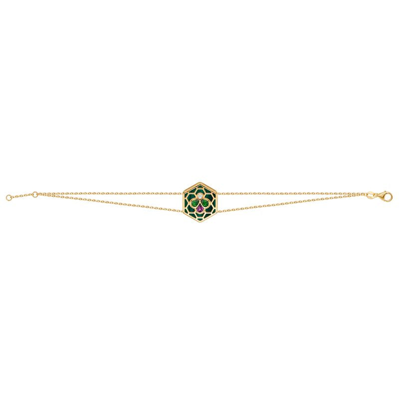 A delicate gold double chain bracelet featuring a central hexagonal charm with a green and red floral pattern, set against a plain white background.