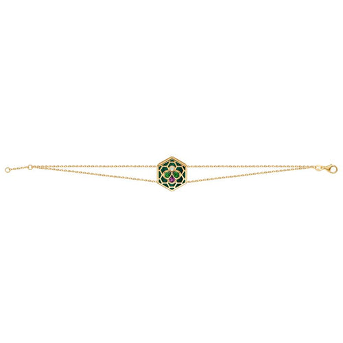 A delicate gold double chain bracelet featuring a central hexagonal charm with a green and red floral pattern, set against a plain white background.