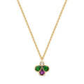 A gold chain necklace with a clover-shaped pendant featuring a small round diamond at the top, a green teardrop-shaped stones on the left and right, and a purple teardrop-shaped stone in the midlle, set against a plain white background.