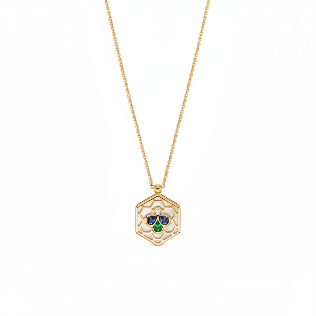 A gold chain necklace with a hexagonal pendant featuring a white center, a small clear stone, and a three-stone clover motif in blue, green, and gold.