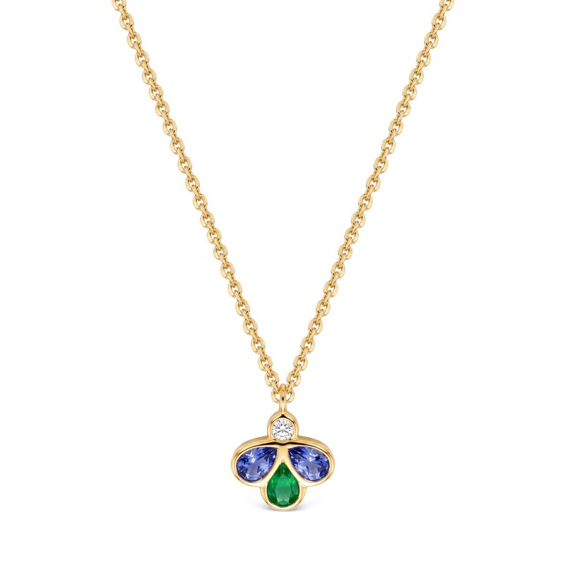 A gold chain necklace with a small clover-shaped pendant featuring a central round diamond, a two blue gemstones, and a bottom green teardrop gemstone, shown on a plain white background.