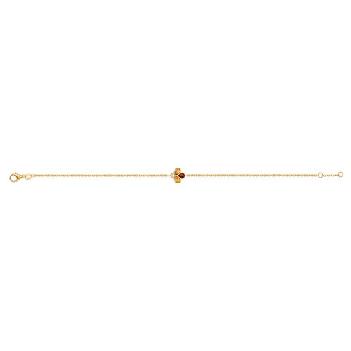 A delicate yellow gold chain bracelet featuring a central clover-like charm with two yellow gemstones, one amber-orange gemstone, and a small clear accent stone, shown on a plain white background.