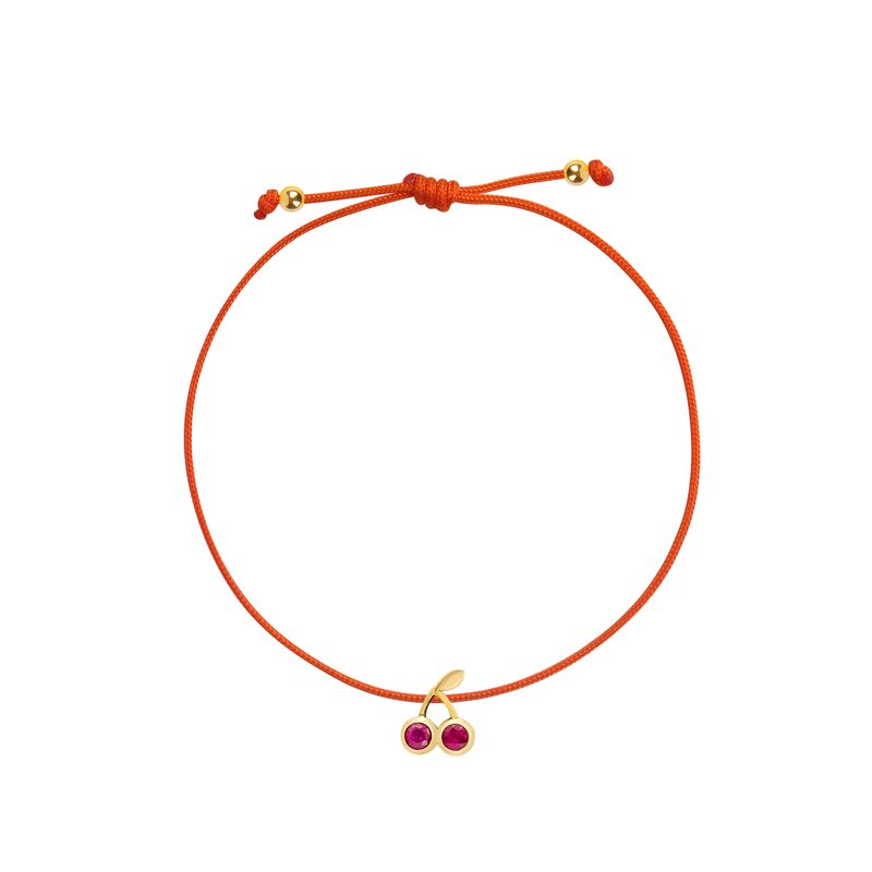An adjustable orange cord bracelet featuring a gold-tone cherry charm with two small red gemstones, displayed on a clean white background.

