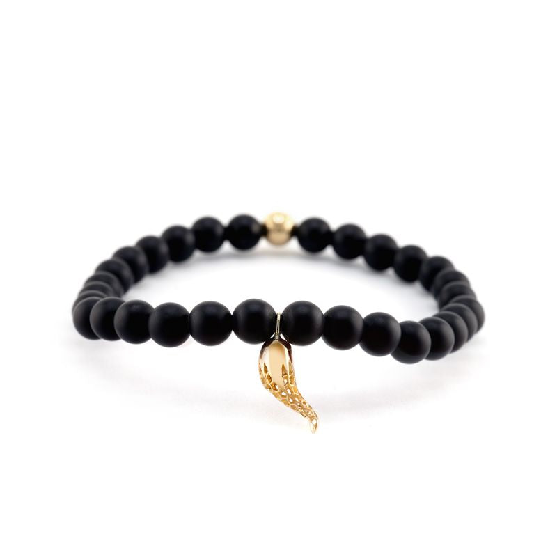 A beaded bracelet featuring matte black round beads, a small gold spacer bead, and a textured gold horn charm, displayed on a clean white background.