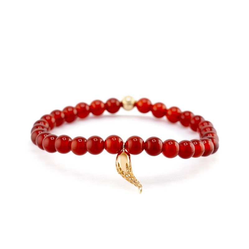 A red beaded bracelet with a small gold horn charm, displayed on a clean white background.