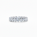 A white gold diamond eternity band ring featuring a continuous row of Heart Shaped-cut lab grown diamonds set in a polished silver-colored metal, shown against a plain white background.