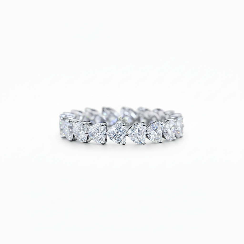 A white gold diamond eternity band ring featuring a continuous row of Heart Shaped-cut lab grown diamonds set in a polished silver-colored metal, shown against a plain white background.