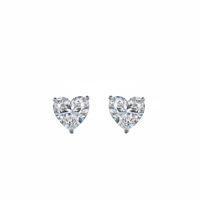 Pair of white gold heart-shaped stud earrings on a white background