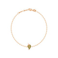 A delicate rose gold chain bracelet with a small leaf-shaped charm paved with green stones, displayed on a clean white background.