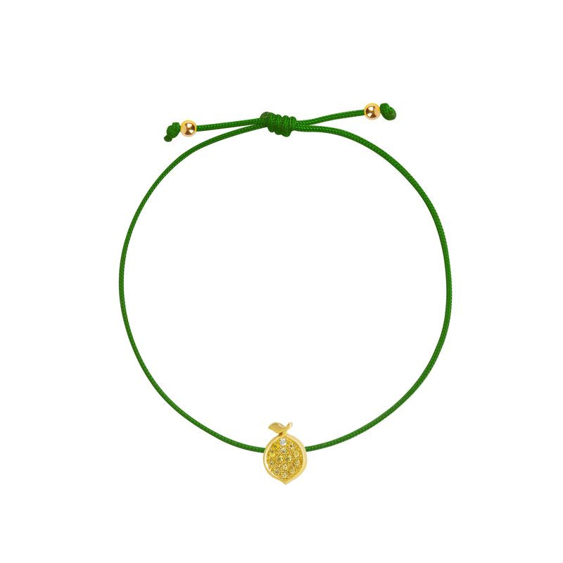 A delicate green cord bracelet featuring a small textured yellow gold lemon charm and adjustable sliding knot with gold accent beads, shown on a plain white background.