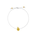 A delicate white cord bracelet featuring a small textured yellow gold lemon charm and adjustable sliding knot with gold accent beads, shown on a plain white background.