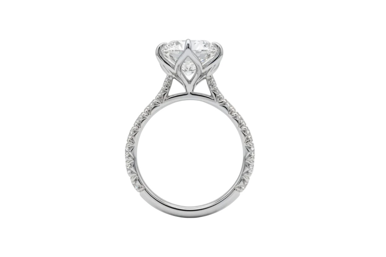 A Platinum diamond engagement ring with a large marquise-cut center stone in tulip setting a pavé-set diamond band, shown from the side on a white background.