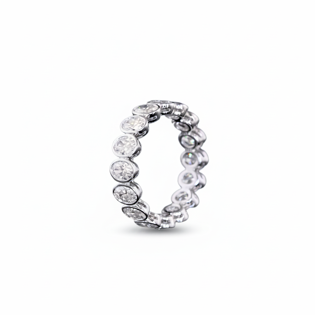 A white gold Oval Diamond Bezel set eternity ring featuring a continuous row of Oval lab grown diamonds, shown on a clean white background.