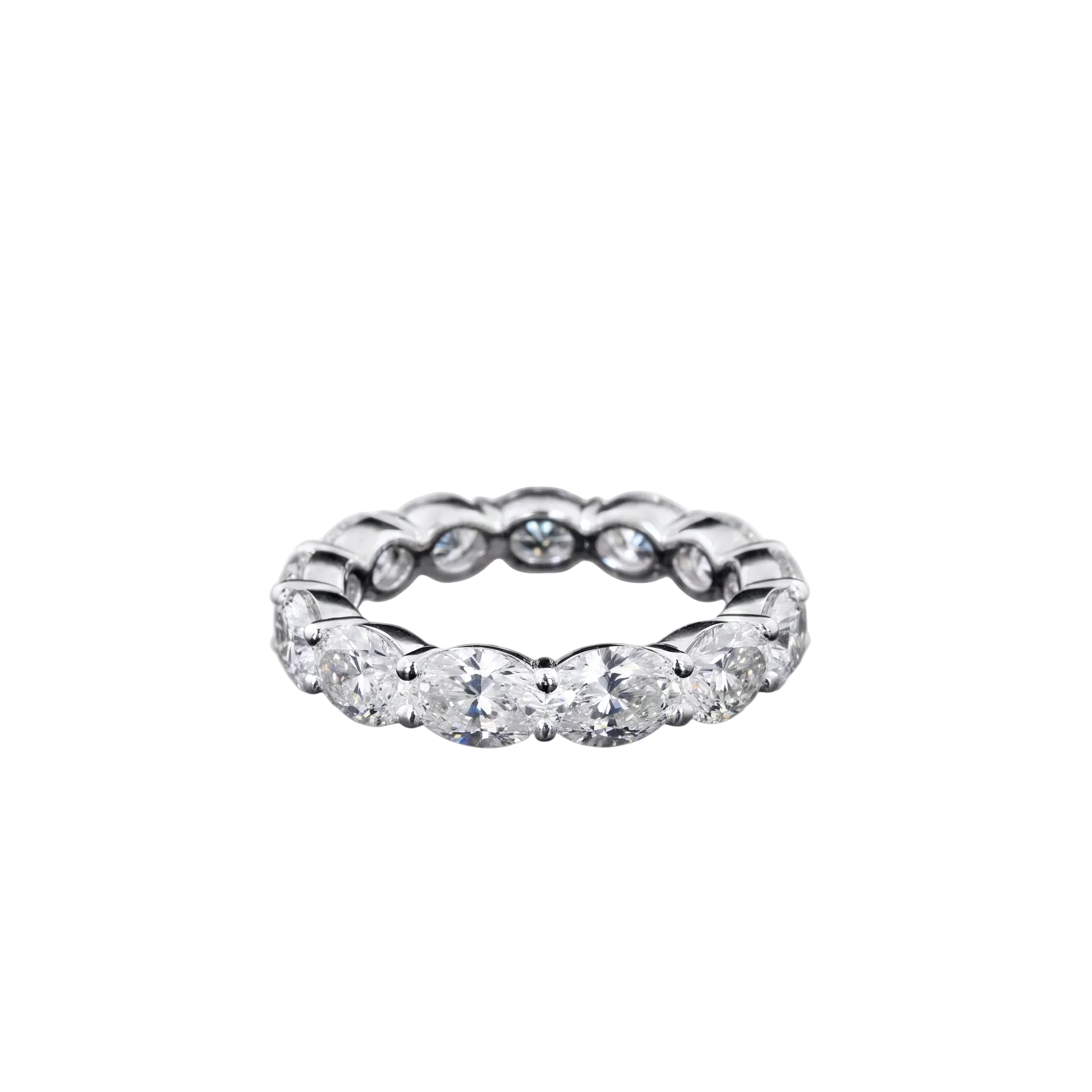 A white gold eternity ring featuring a continuous row of oval-cut lab grown diamonds, photographed on a seamless white background.