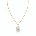 A yellow gold necklace with a single solitaire pear diamond pendant, displayed against a solid white background.